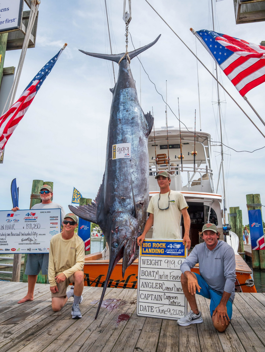 Marlin Fever crew with the record 919.9-pound blue marlin at Big Rock Landing in Morehead City NC, June 9 2026 — angler Connor Daniel and Captain Cameron Guthrie, the 2026 Big Rock Blue Marlin Tournament champions. Photo: Big Rock Blue Marlin Tournament.