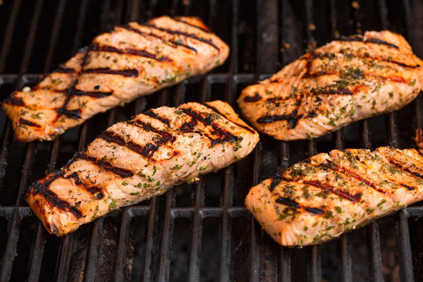 Salmon fillets cooking on a hot grill with marinade — Cooking Classy