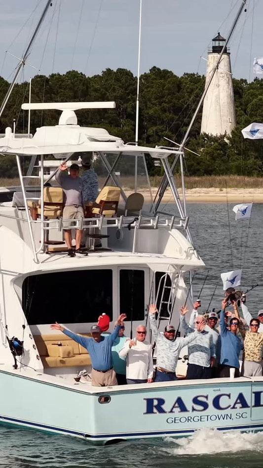 The Rascal team celebrating their 58th Annual Georgetown Blue Marlin Tournament victory in front of the Georgetown lighthouse — image via SC Governor's Cup Billfishing Series