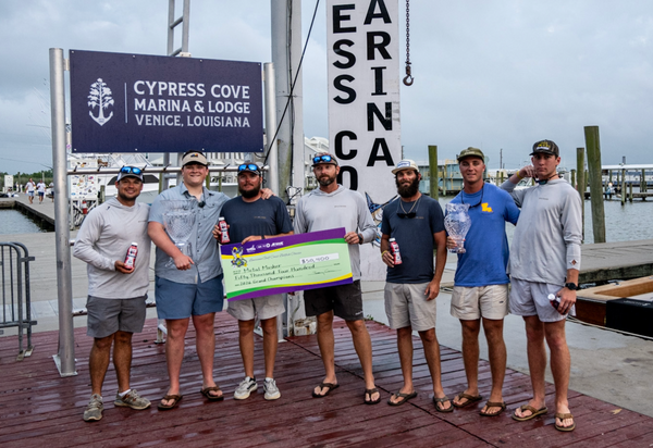 Metal Masher crew accepting the 2026 Louisiana Gulf Coast Billfish Classic Grand Champion check on the Cypress Cove Marina dock in Venice, Louisiana.