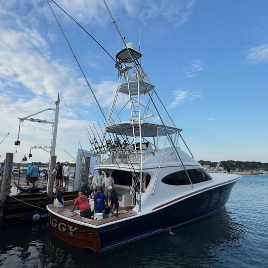 A sportfishing convertible backs into the weigh station at the 2026 Montauk Canyon Challenge as crew wait on the dock