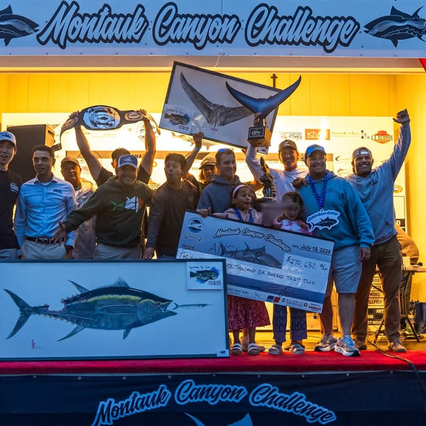 Winning team holds a Montauk Canyon Challenge check on the awards stage at Gosman's Dock in Montauk