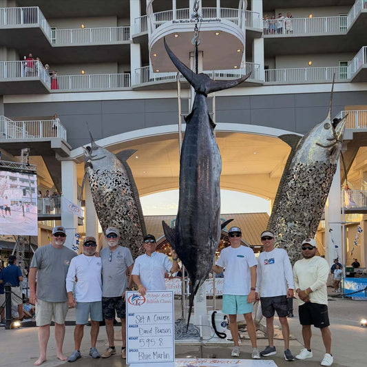 Set A Course crew on the 2026 Orange Beach Billfish Classic awards stage at The Wharf with the 595.8-pound blue marlin and the championship winner board.