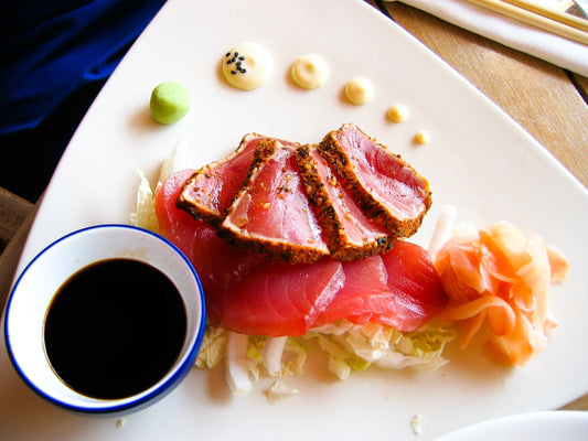 Seared yellowfin tuna sliced and plated, finished with citrus soy and sea salt — a simple recipe for the first tuna of summer