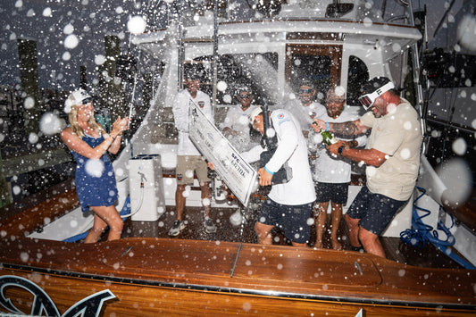 Third Coast Renegades spray champagne with the SFC winner check after winning the Bay Point Billfish Open Gulf Division stop June 27 2026 - photo by Sport Fishing Championship
