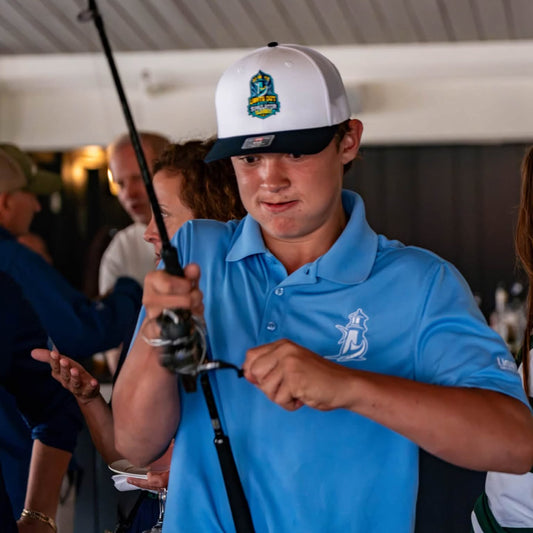Angler rigs tackle at the 2026 SFC Cape Cod Invitational at MacDougall's Marina.