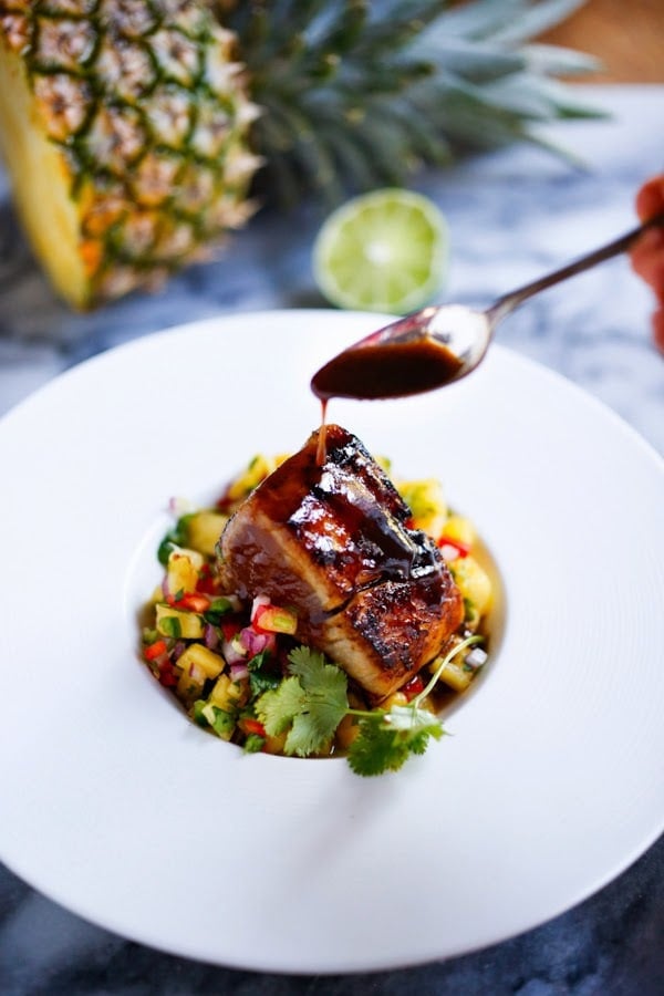 Grilled wahoo fillet plated with charred pineapple–habanero salsa over coconut rice
